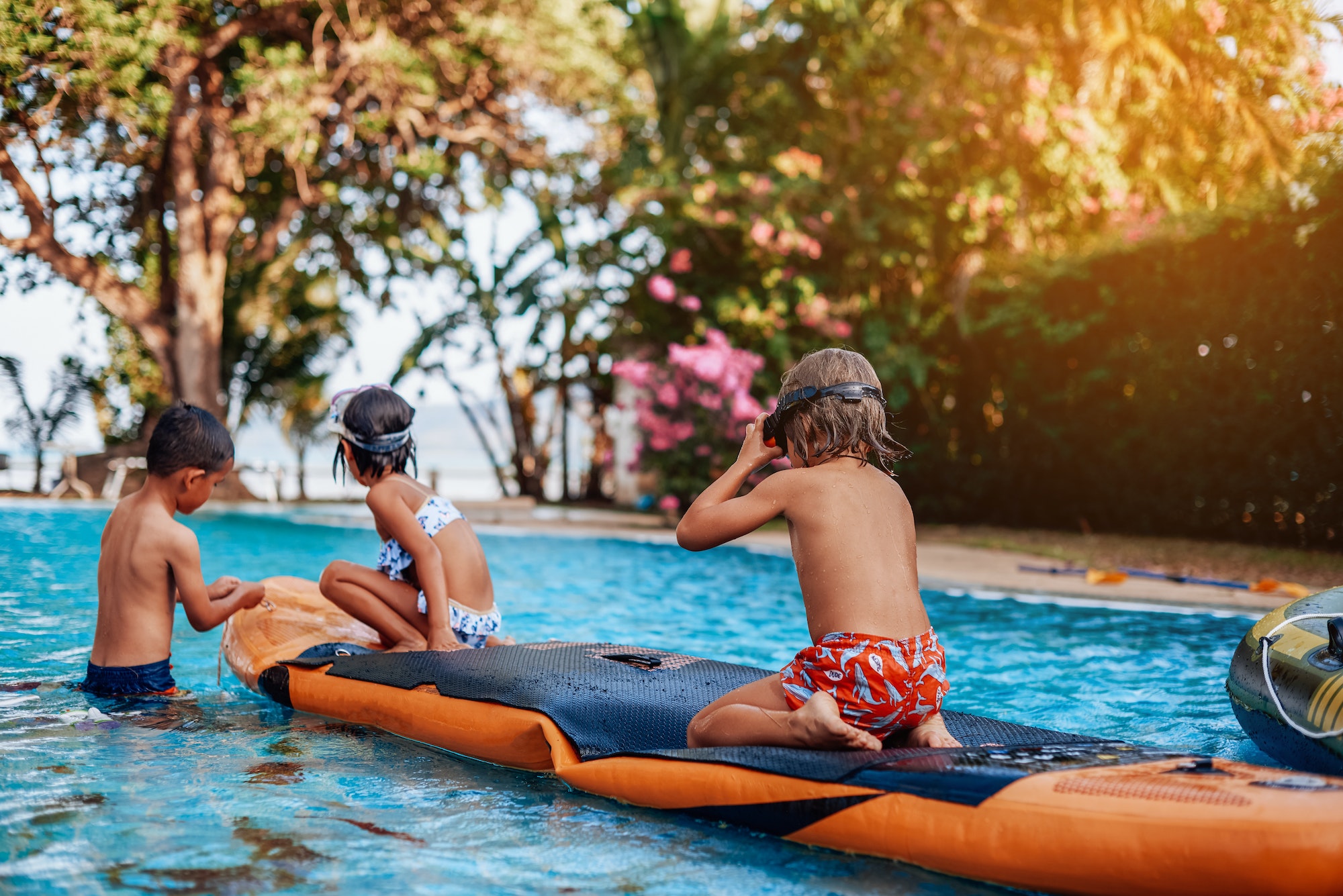 relaxed-children-swim-in-pool-together-with-boat-in-hotel.jpg